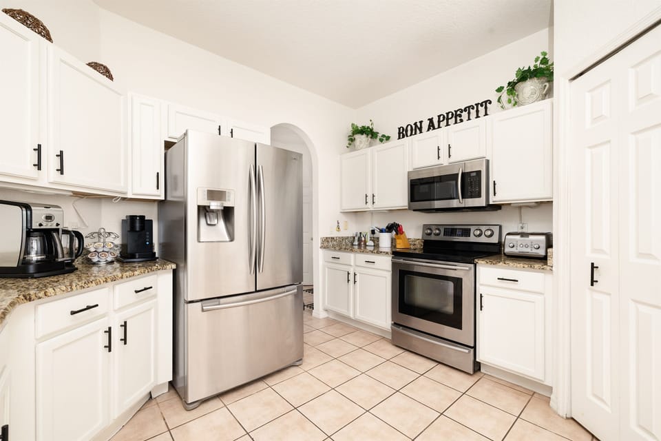 Modern kitchen with granite counters and SS applainces.