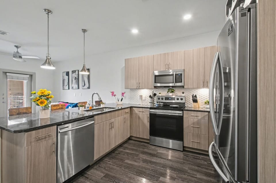 - Sleek kitchen design with modern cabinets and island sink - Stainless steel fridge oven microwave and dishwasher - Open living dining area perfect for group stays
