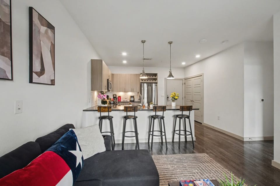 - Open concept living area with granite kitchen island - Bar seating stainless steel appliances and pendant lighting - Perfect space for dining entertaining and relaxing nights