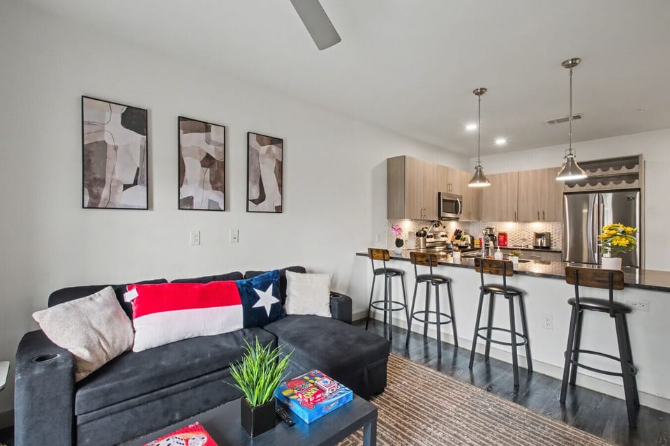 - Modern open concept living room with smart TV and balcony access - Stylish kitchen with granite island and stainless steel appliances - Cozy lounge with high speed WiFi perfect for extended stays