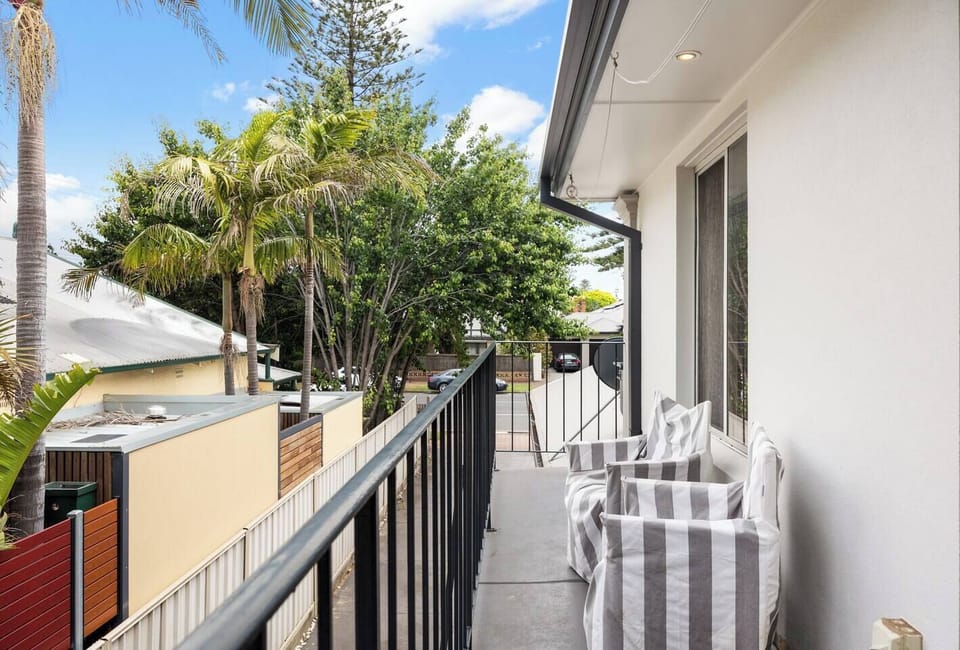 The balcony offers a breezy retreat with two lounge chairs and elevated treetop outlooks, an ideal spot for savouring your morning coffee.