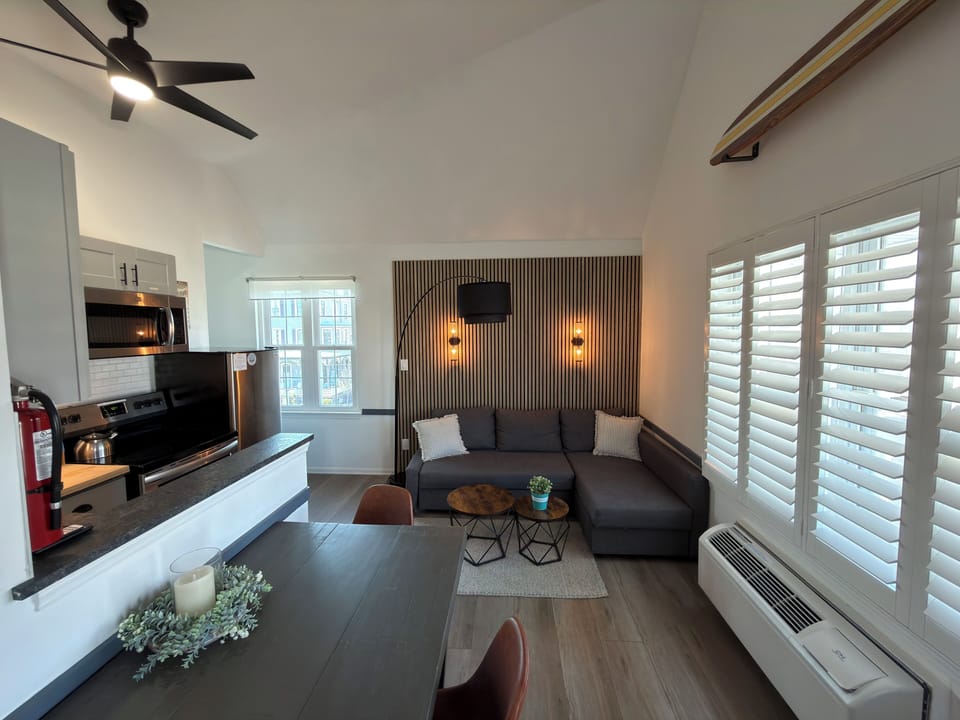 Bright modern loft with vaulted ceilings, stylish lounge, and sleek kitchen