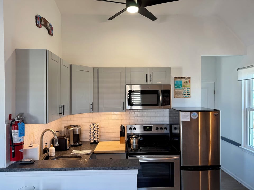 Bright modern kitchen with vaulted ceilings and stainless appliances