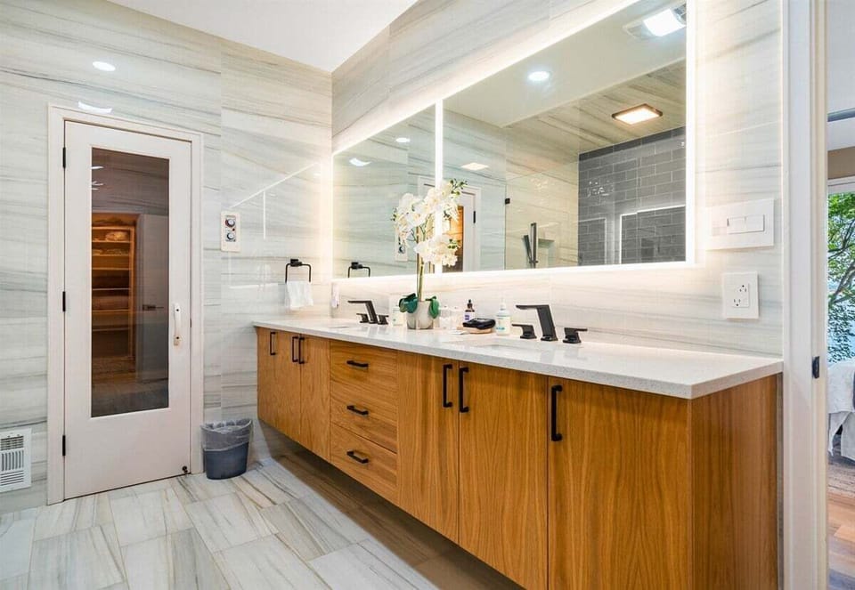 Spacious bathroom with modern finishes and double sinks.
