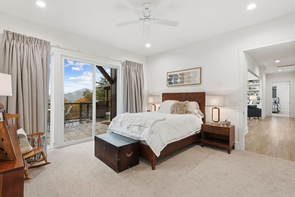 Sunlight fills this expansive bedroom, highlighting cozy touches and a tranquil atmosphere perfect for unwinding.