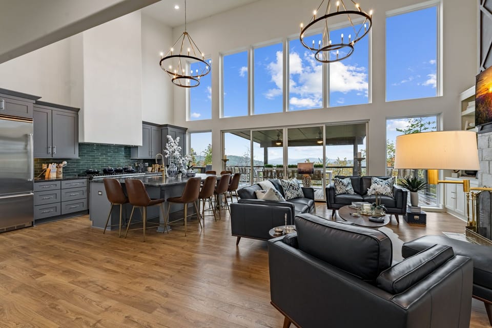 Soaring ceilings, natural light, and panoramic windows frame the breathtaking mountain scenery beyond.