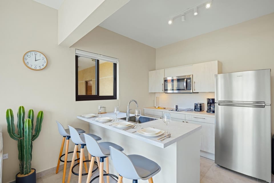 This fully-equipped kitchen and stylish breakfast bar is the perfect spot for your morning coffee or a home-cooked meal.
