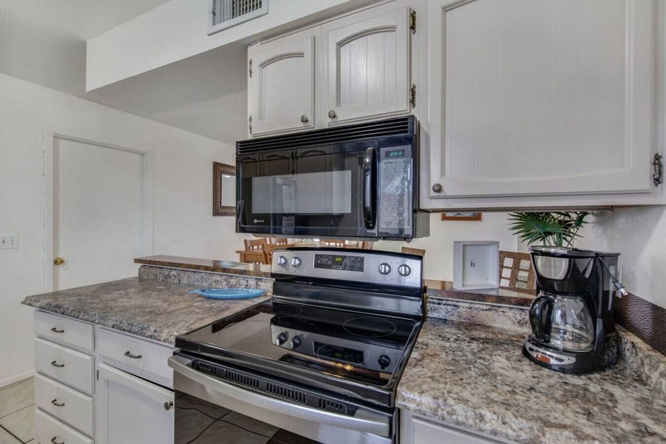 Fully stocked kitchen with stove and coffee maker