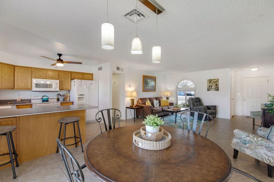 Open-concept dining area with bar seating, flowing seamlessly into the kitchen and living room.
