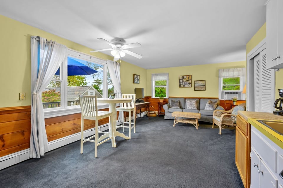 Bright, open-plan living and dining space with picturesque cove views