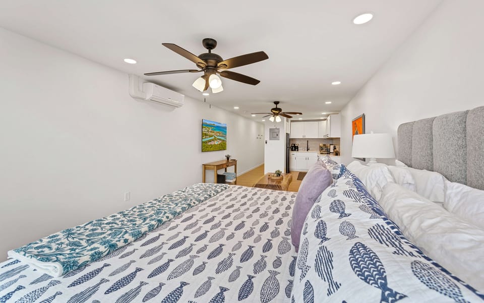 Spacious simple area with a living room that has a smart flat screen TV and cable. Ceiling fans in both spaces to keep you cool
