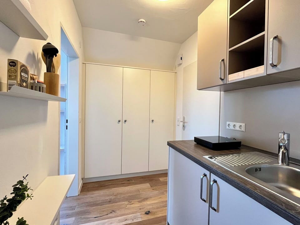 Wall, Interior Design, Countertop, Flooring, Cabinetry, Wood, Kitchen, Floor, Room, Furniture