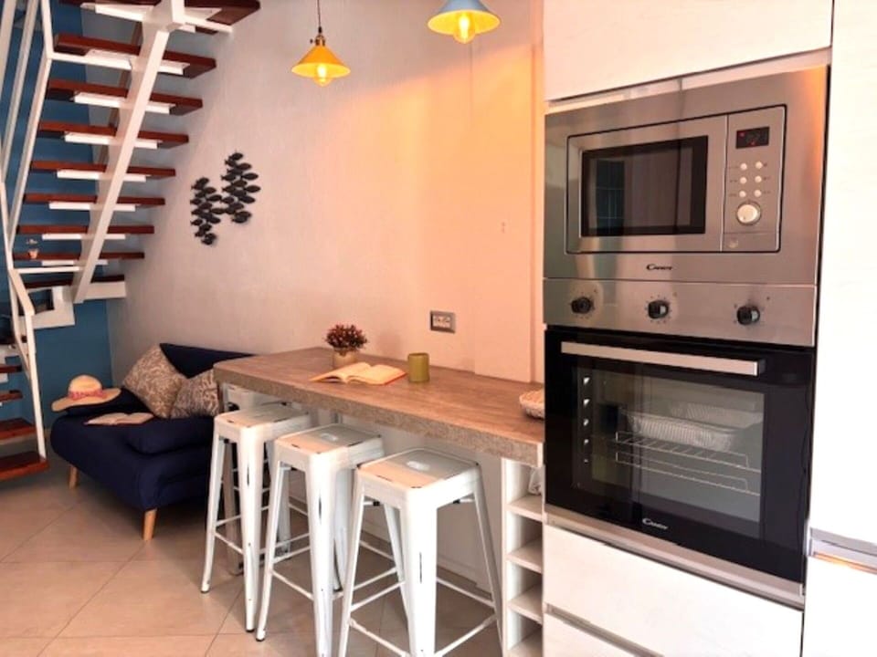 Furniture, Interior Design, Flooring, Kitchen Appliance, Floor, Kitchen, Wood, Major Appliance, Countertop, Cabinetry