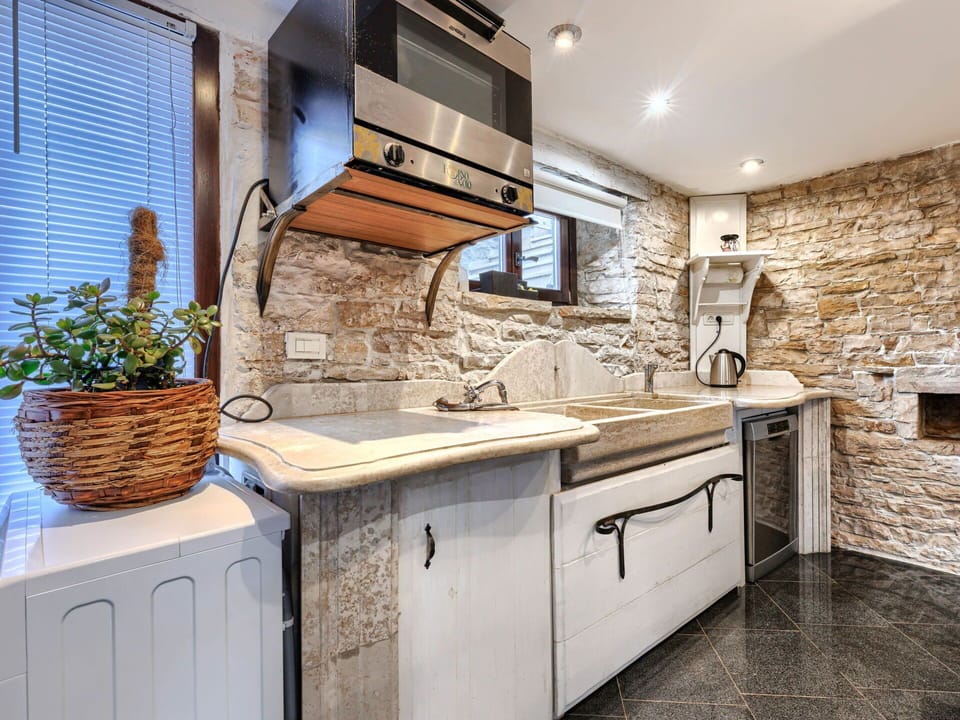 Kitchen, Countertop, Flooring, Interior Design, Sink, Furniture, Plumbing Fixture, Cabinetry, Tap, Kitchen Appliance