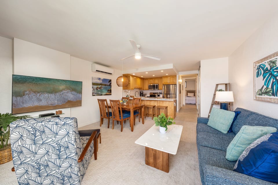 Relax in this spacious open‑concept living area featuring a comfortable lounge, dining space, and a fully equipped modern kitchen.