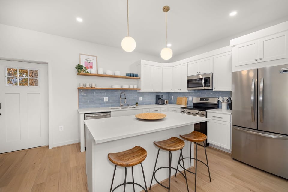 Designer kitchen with stainless appliances and quartz countertops