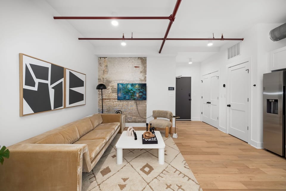 Living area with brick column and wall-mounted Smart TV

