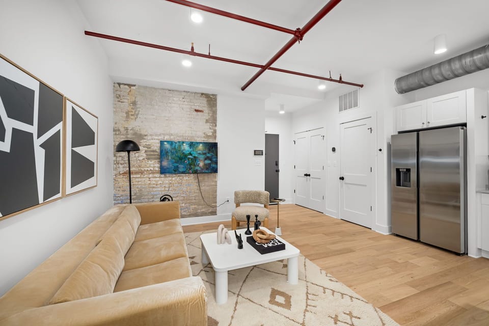 Red ceiling pipes and exposed ductwork create an unmistakable loft aesthetic

