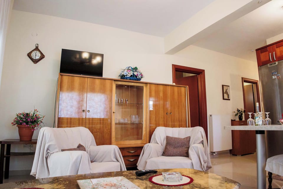 Relaxing lounge with sofa, armchairs, and TV, creating a welcoming space for downtime after a full day.