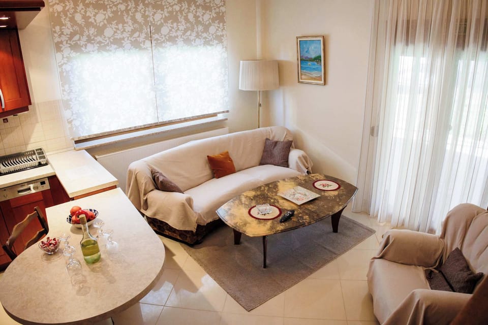 Bright, airy living area with stylish seating and large windows that fill the room with natural light.