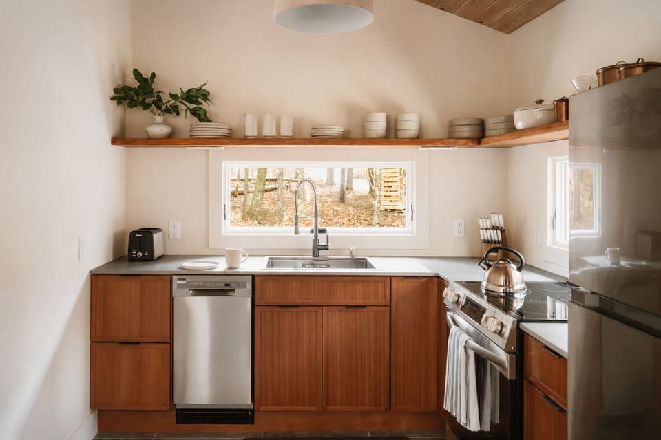 Toast some bread and pour a bowl of cereal, or run the dishwasher after cooking a full meal. Dishes and mugs are stacked on the open shelf above the sink, ready whenever you need them.