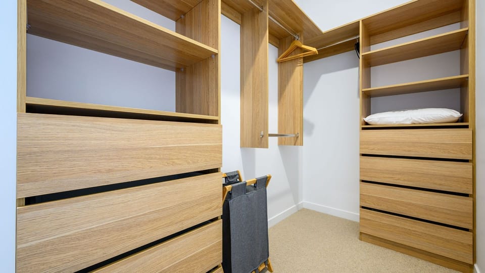 Spacious walk-in wardrobe with ample storage for extended stays.