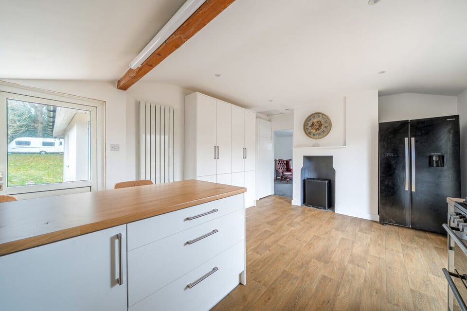 Modern kitchen with farmhouse-style details and garden access.