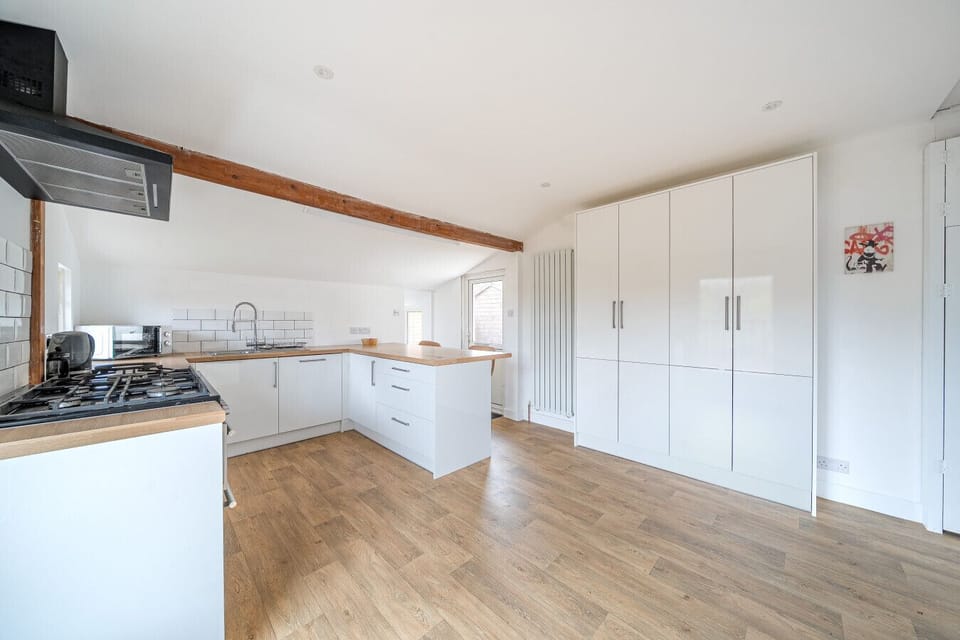 Open kitchen layout with full-height cupboards and ample workspace.