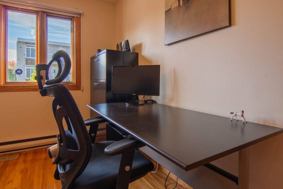Dedicated workspace with desk and ergonomic chair.
