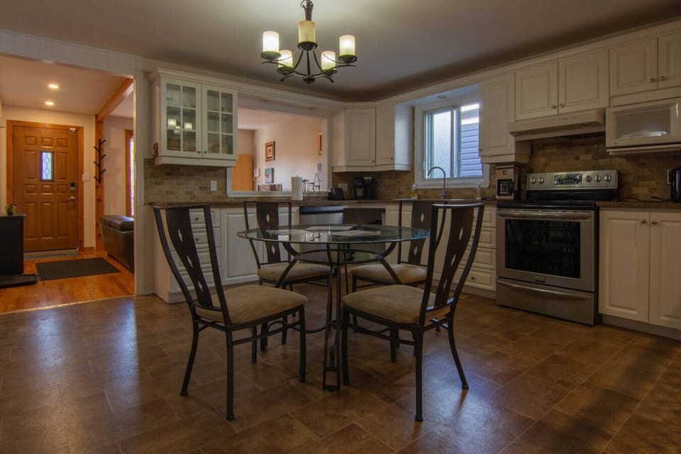 Fully equipped kitchen with dining area for shared meals.