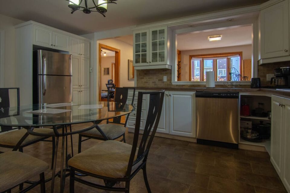 Fully equipped kitchen with dining area for shared meals.