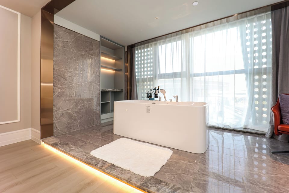 Privilege, Suite, 1 King Bed | Bathroom | Shower, hair dryer, slippers, towels