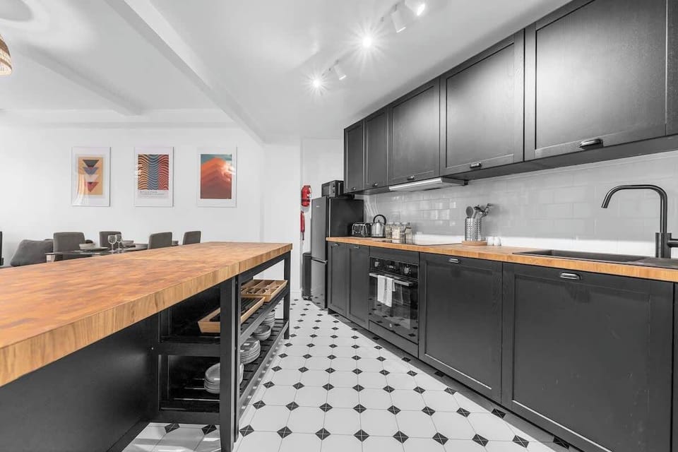 Sleek main bathroom with fresh towels, rainfall shower and space to get ready for a night out in the city