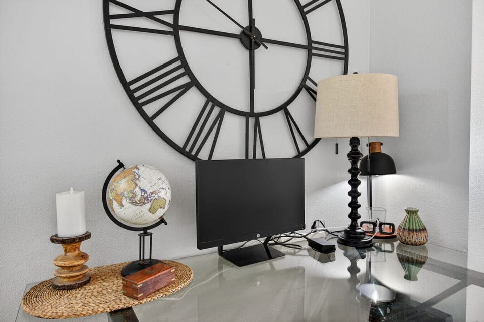 Dedicated workspace w/ desk, lamp, and decor, great for remote work or trip planning.