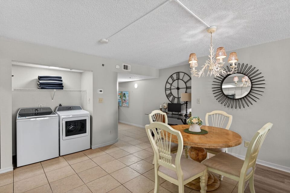 Inviting dining nook w/ stylish lighting, perfect for relaxed meals just steps from the kitchen.