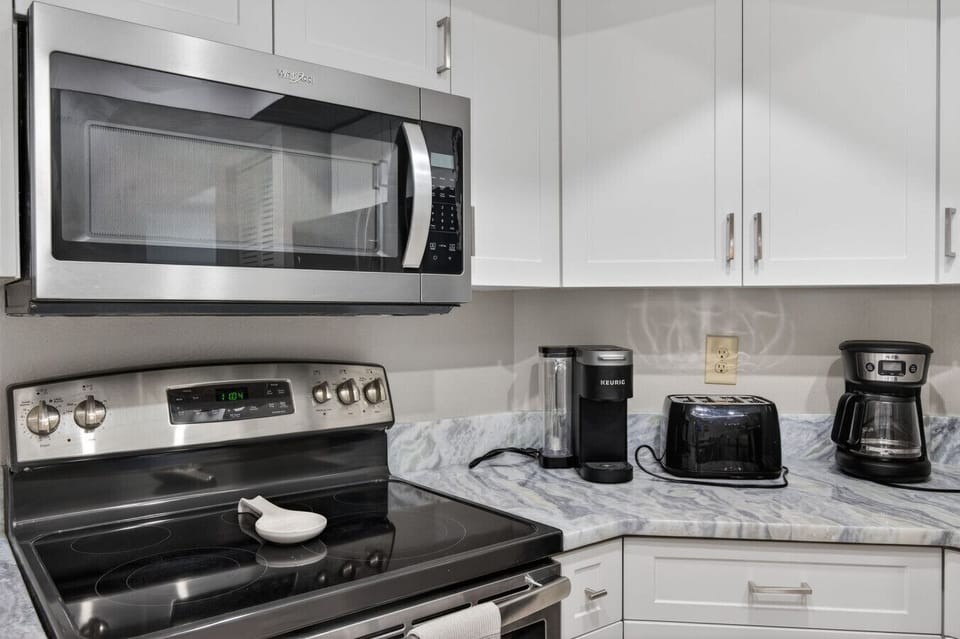 Close-up of stainless appliances and counter space, perfect for cooking and quick breakfasts.