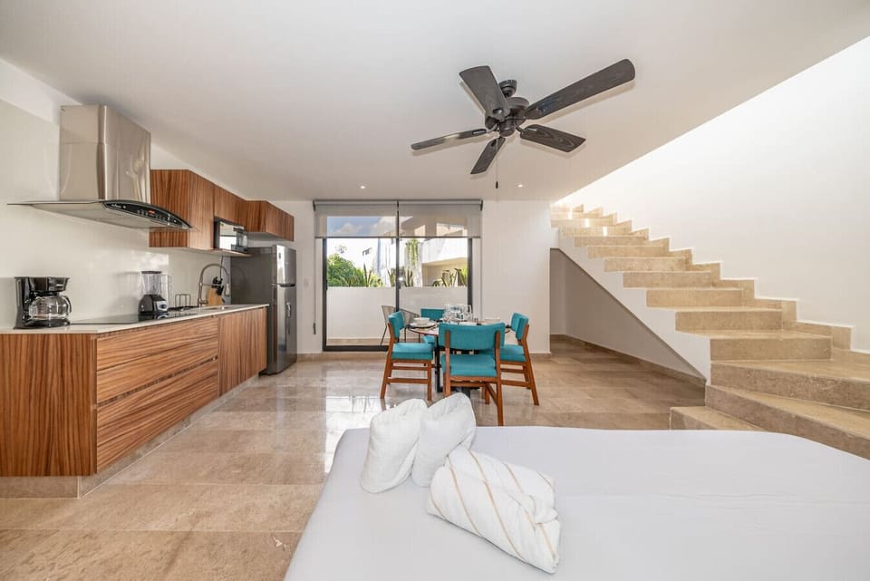 Open layout with kitchen, dining table and king bed — perfect for relaxing after exploring Tulum.