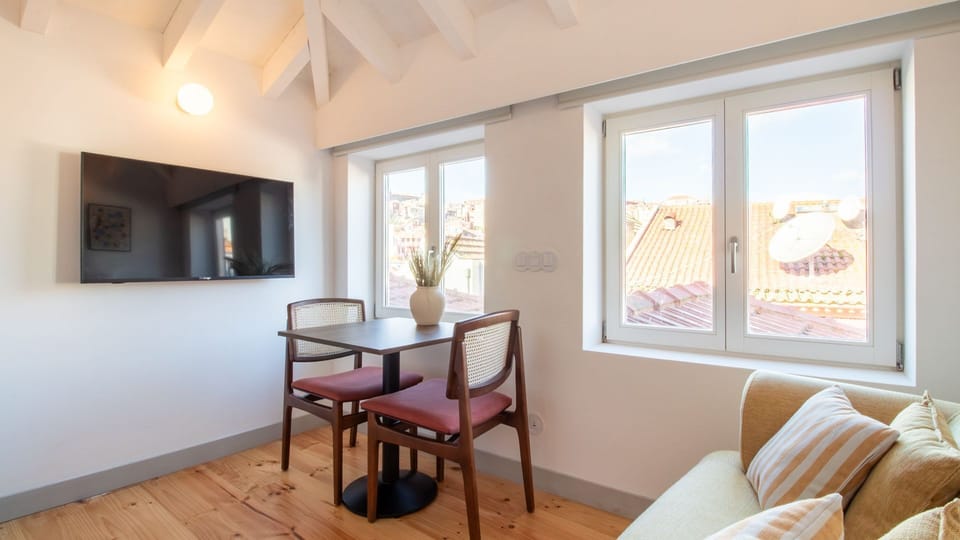 Open-plan living room with smart TV and curated décor, perfect for unwinding after exploring the city. #AirbnbPlusVibes #PortoApartment #StylishStay