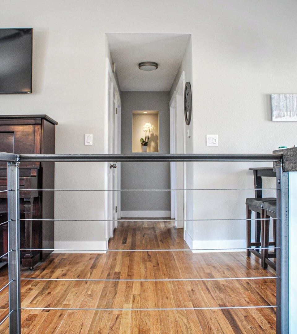 Looking down hall through cable railing