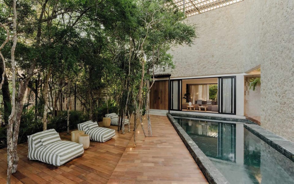 Central pool patio surrounded by lush jungle greenery.