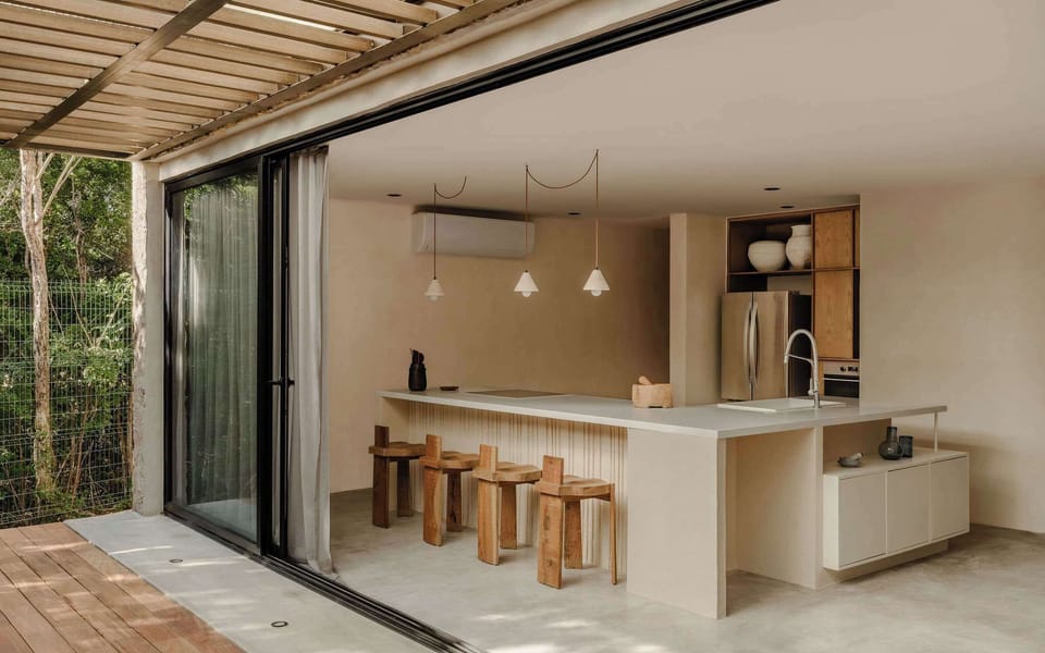 Open-plan kitchen and dining area flowing toward the jungle.