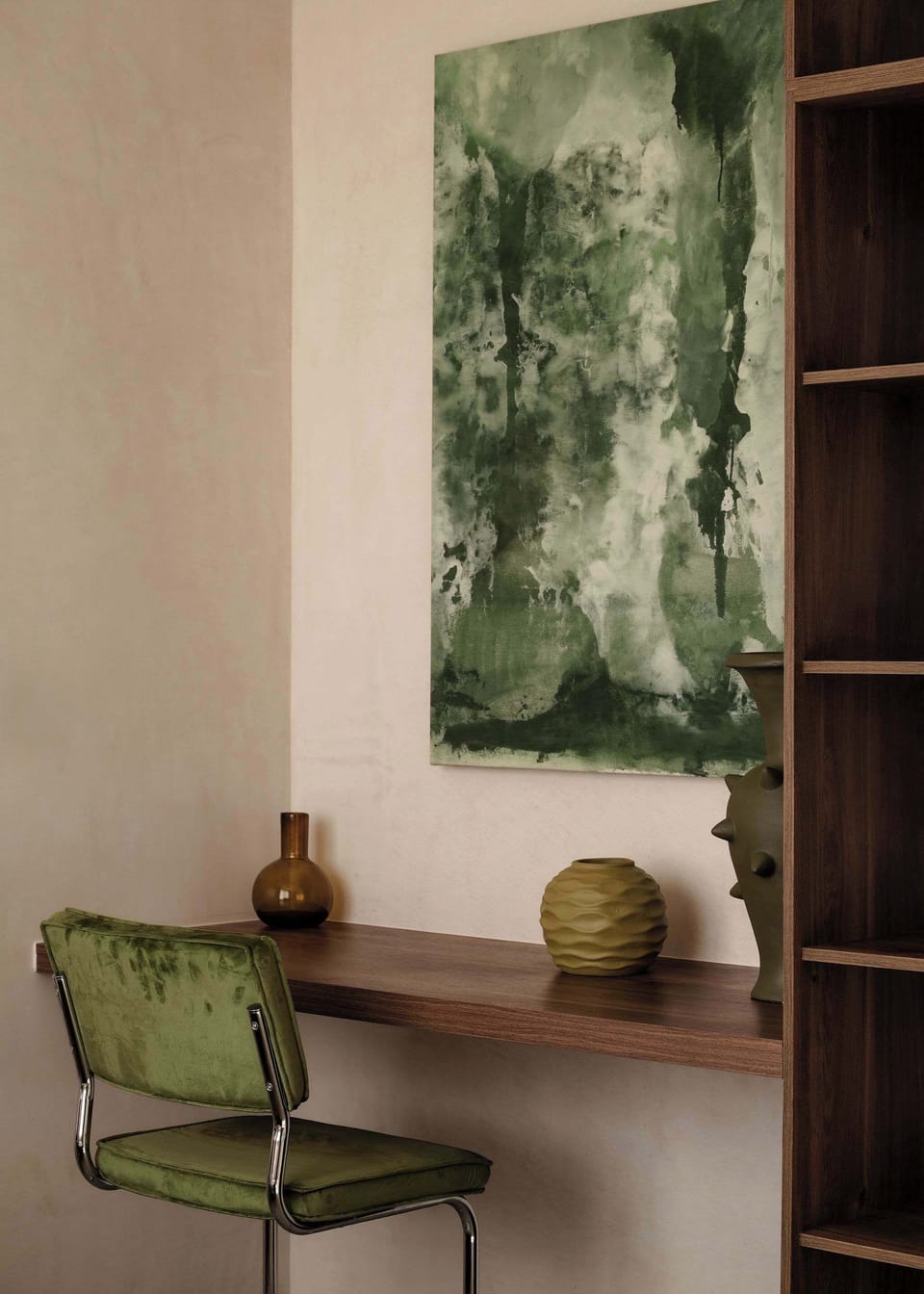 Small workspace area with botanical artwork and curated décor.