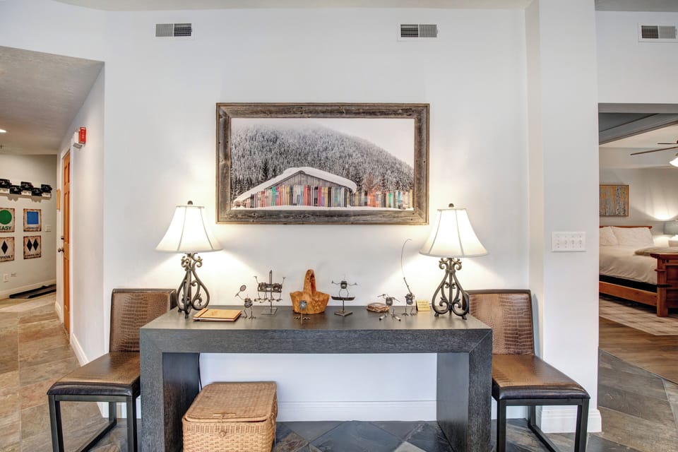 Settle into your stylish entryway featuring a sleek console table with decorative lamps.