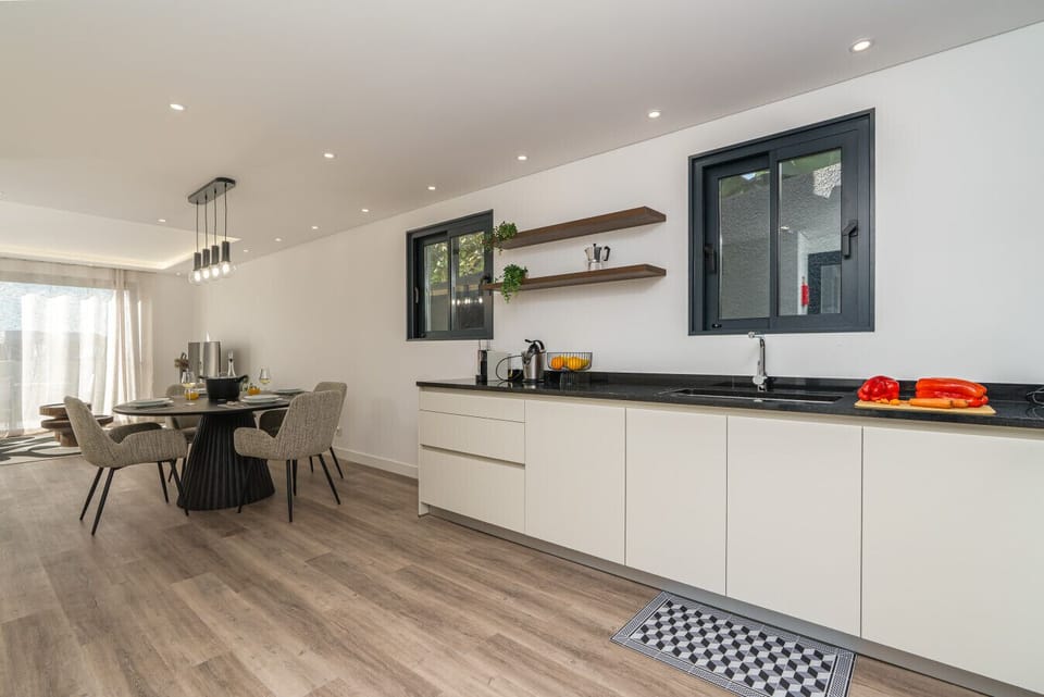 Open-plan kitchen flowing to dining and lounge.