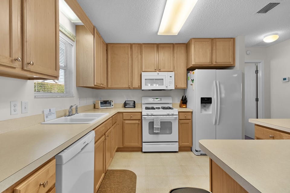 Your fully equipped kitchen awaits with stainless steel appliances, ample counter space, and warm wood cabinetry for memorable meal preparation.