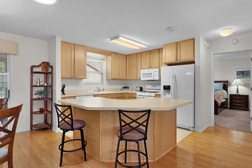 Cook your favorite meals in this bright, fully-equipped kitchen with modern appliances and a handy breakfast bar for morning coffee.