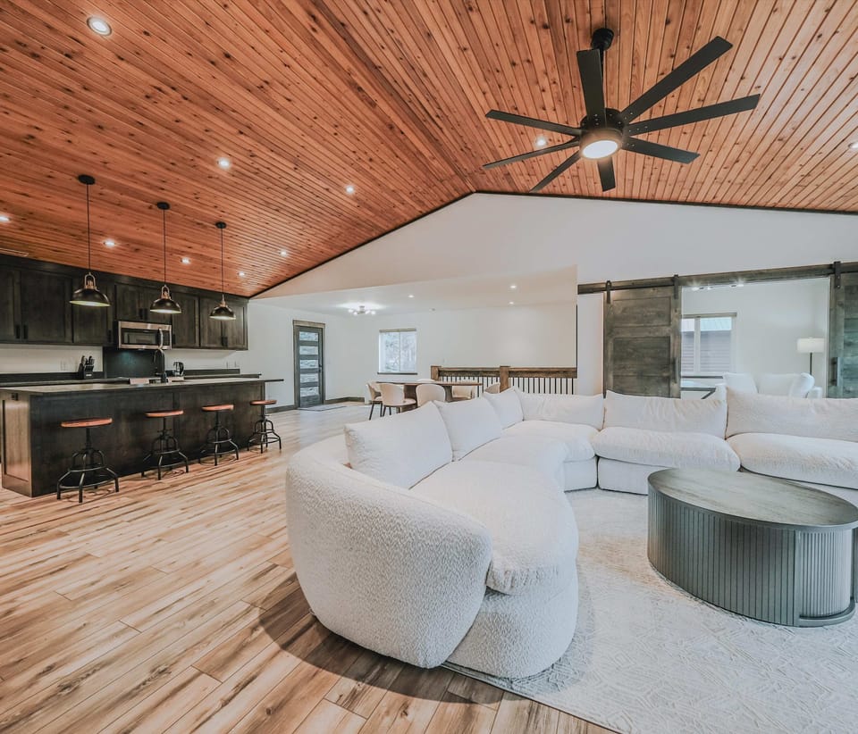 Open living area with Smart TV, large sectional, and lake views 