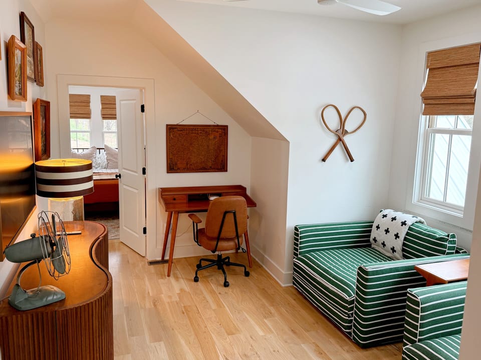 Lounge/tv area with a desk for emails that can't be ignored and two sleepers