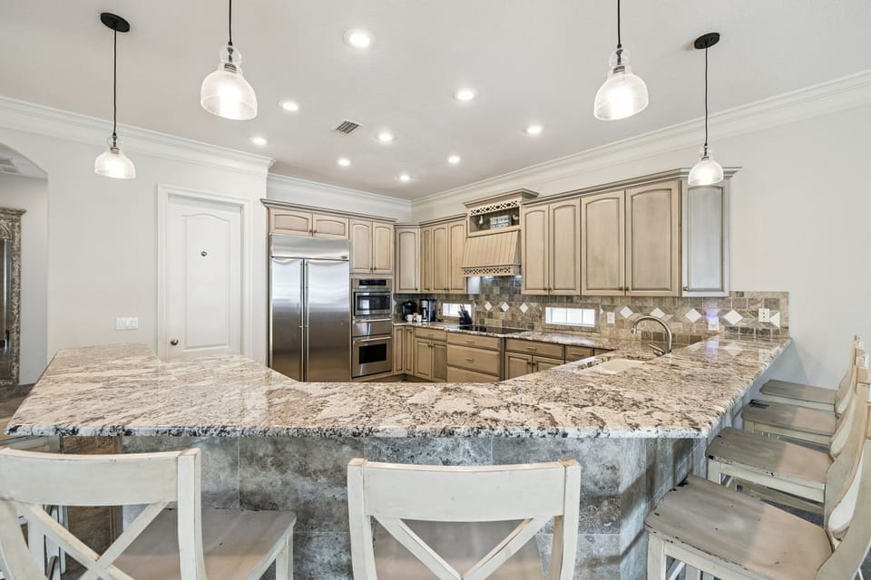 Your gourmet kitchen features granite countertops, stainless steel appliances, and elegant pendant lighting—perfect for cooking memorable meals.