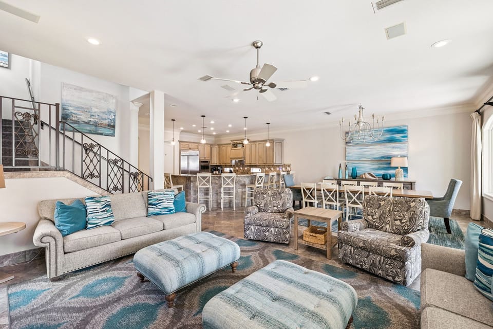 Sink into plush seating with ocean-inspired accents while your group gathers in this bright, open living space flowing seamlessly into the gourmet kitchen.